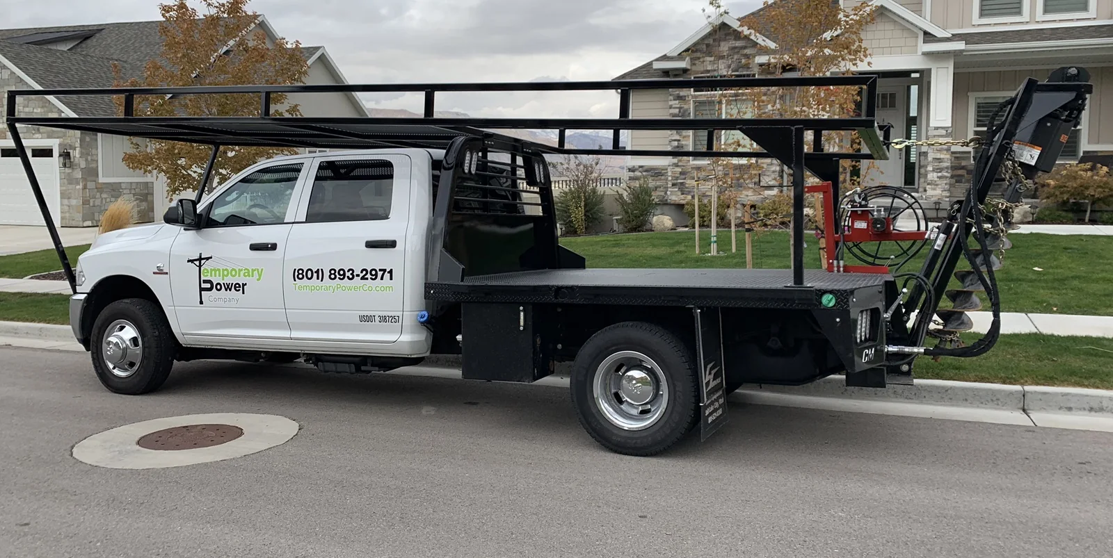 TCS temporary power flatbed service truck on a Utah residential street